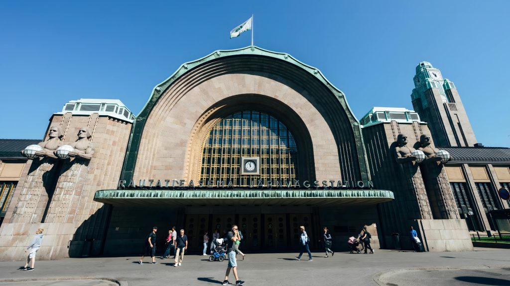 Helsinki Central Station main entrance featuring its iconic granite façade and stone lantern bearers.